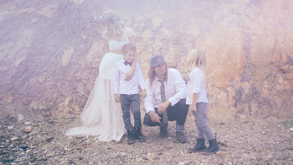 bride, groom and their two sons in the desert.